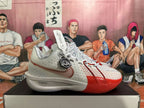 Side view of a white and red Nike basketball shoe showing perforated panels, a Swoosh, and ZoomX lettering.