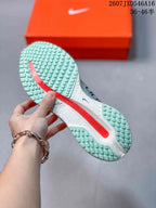 Underside view showing the mint-and-white textured outsole and red central cushioning section.