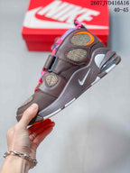 Side view of the brown sneaker showing layered panels, patterned inserts, a white side swoosh, and the heel cushioning unit; image text shows 2607JVD416A16 and 40–45.