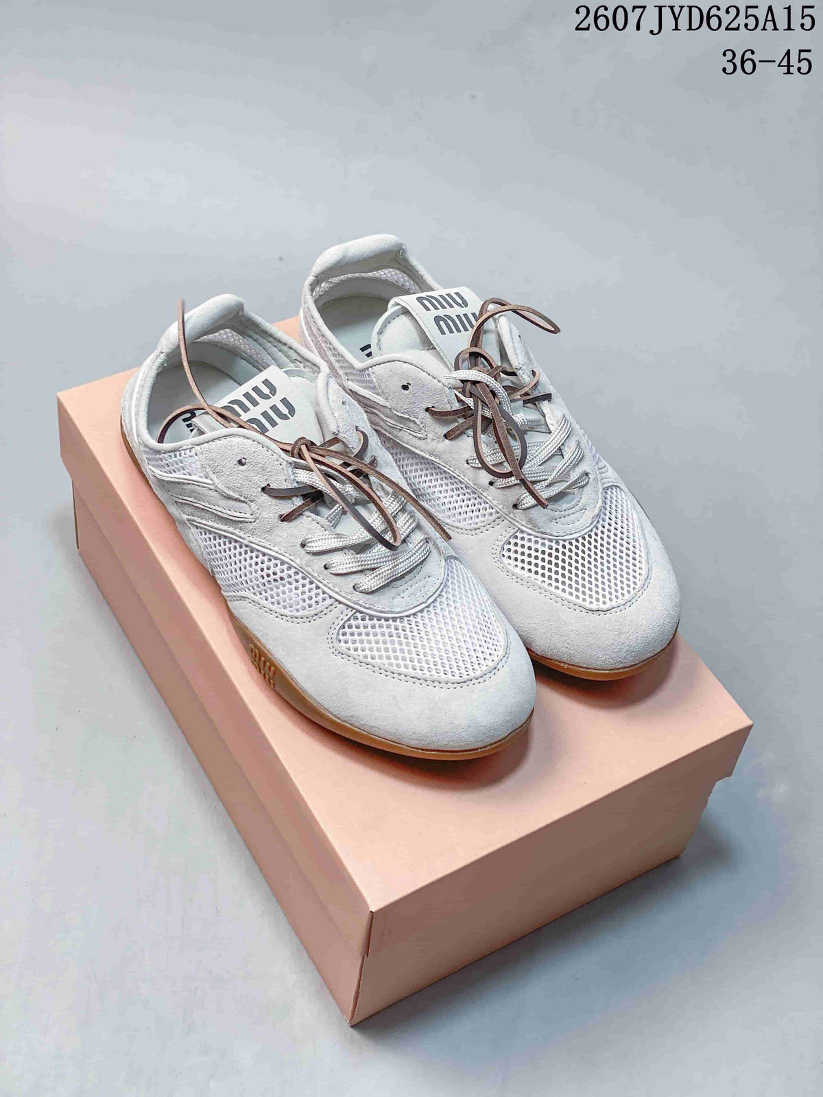 Pair of white and grey Miu Miu low-top sneakers with mesh panels, brown laces, and gum-colored soles on a pink box.