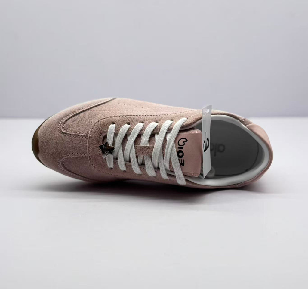 Top view of one sneaker showing the white laces, tongue branding, and pink upper.