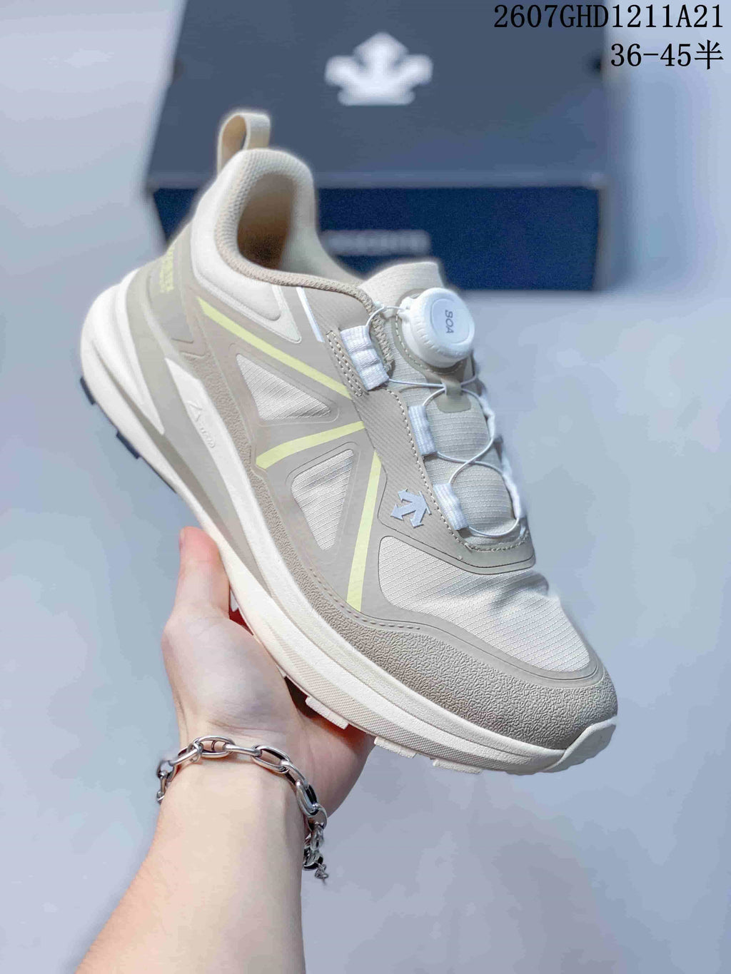 Side and top view of an off-white DESCENTE sneaker with layered panels and a BOA dial closure.