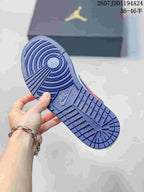Underside view showing the navy patterned outsole of a Jordan low-top sneaker.