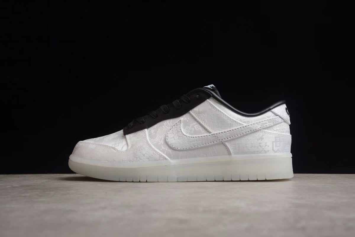 Side profile highlighting the white upper, tonal Swoosh, black collar, and white outsole.