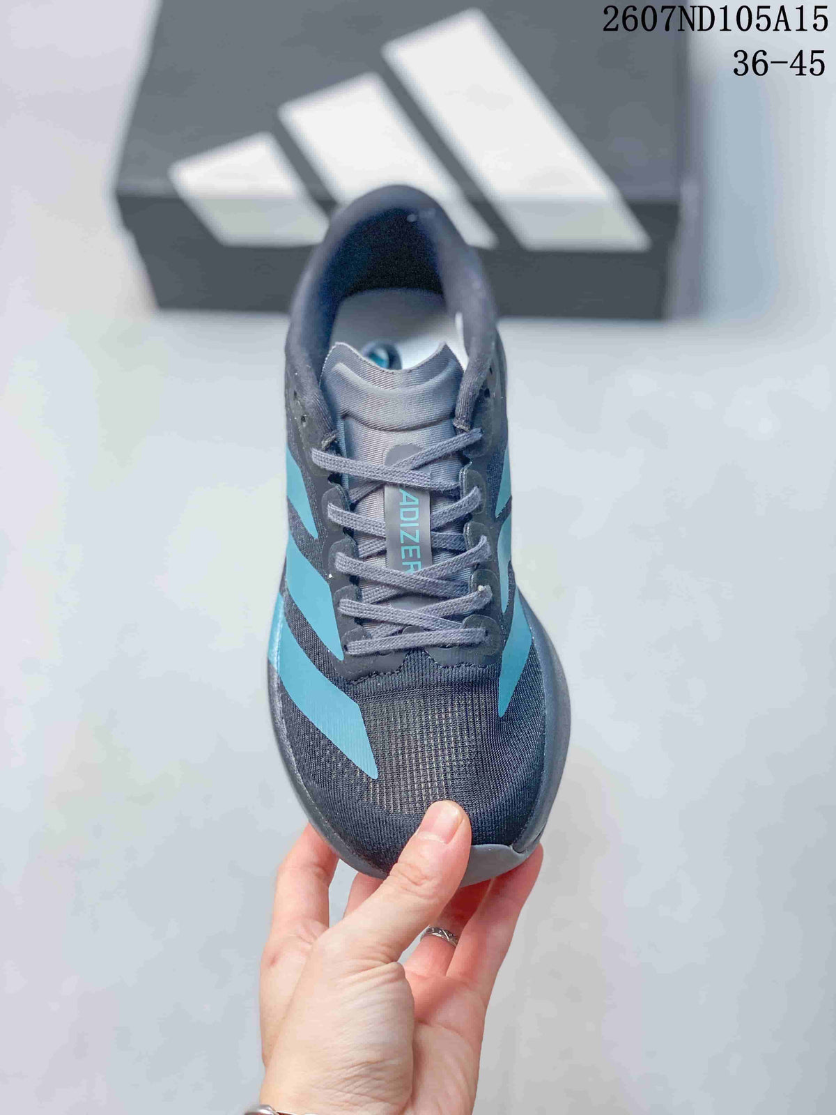 Top view of the lace-up sneaker showing the gray tongue, blue branding and textured toe area.