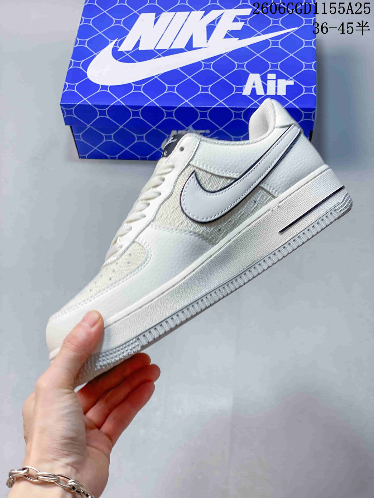 Side view highlighting the dark-outlined Swoosh and contrasting upper panels.