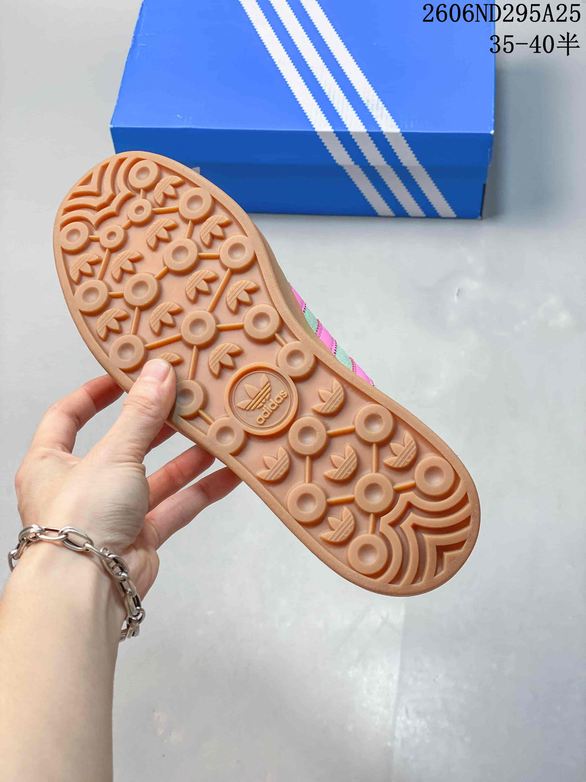 Underside of the sneaker showing a gum-colored outsole with circular and trefoil-pattern tread.