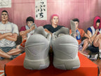 Rear view of gray Nike basketball shoes with pale yellow accents.