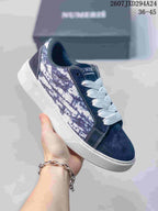 Angled side view of a navy and white NUMERIS sneaker with patterned side panels