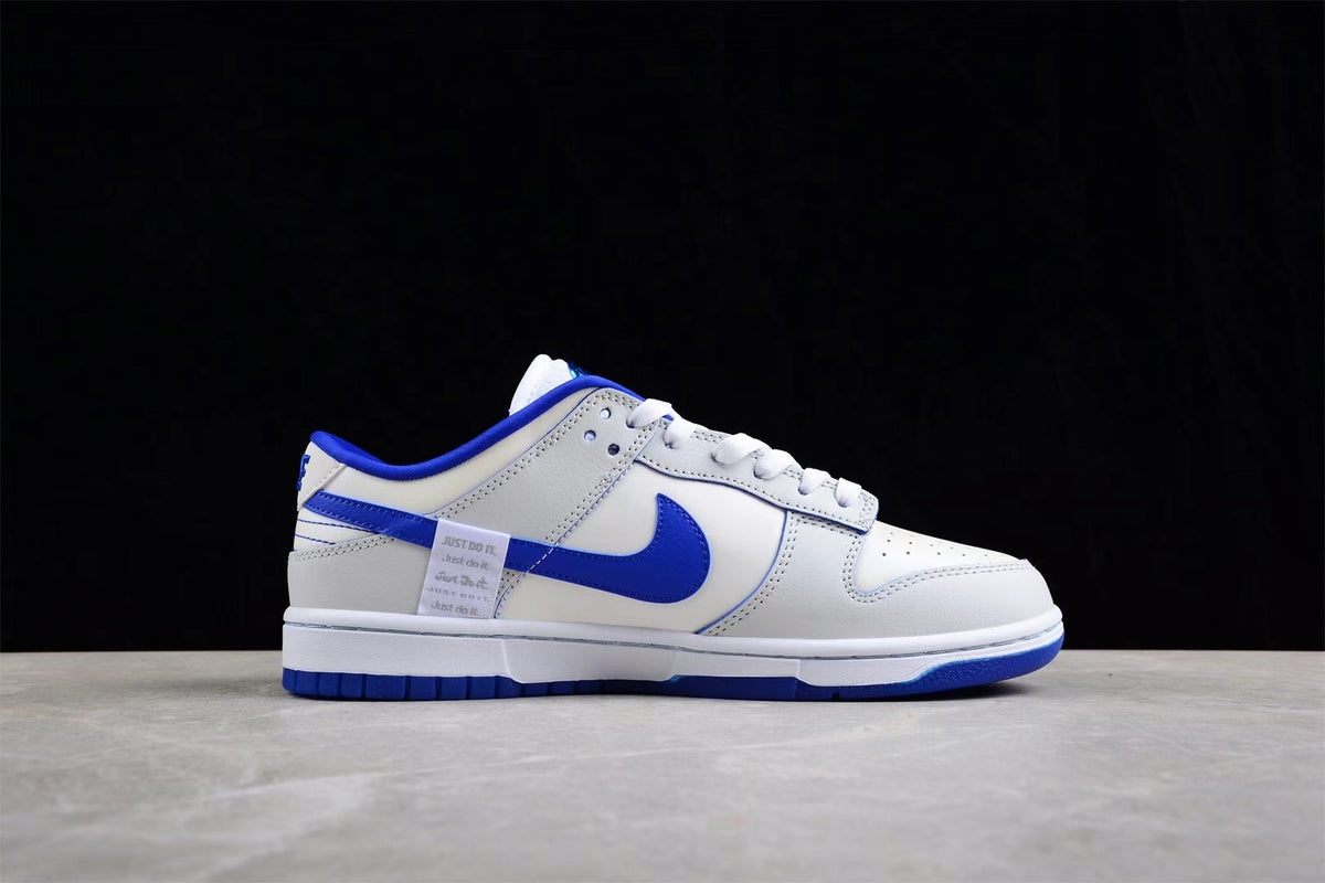 Side profile of a white and blue low-top sneaker with blue side branding and a white midsole.