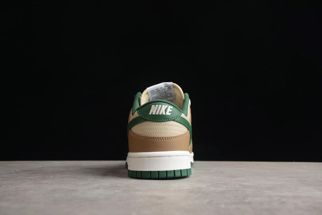 Rear view showing the green heel overlays, cream and brown heel panels, white midsole, and green outsole.