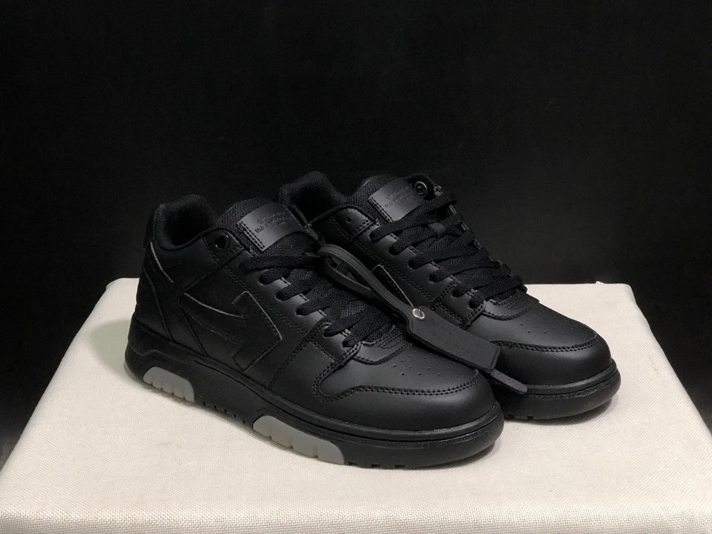 Front three-quarter view of the black sneaker pair with tonal laces, perforated toe panels and attached hangtag.