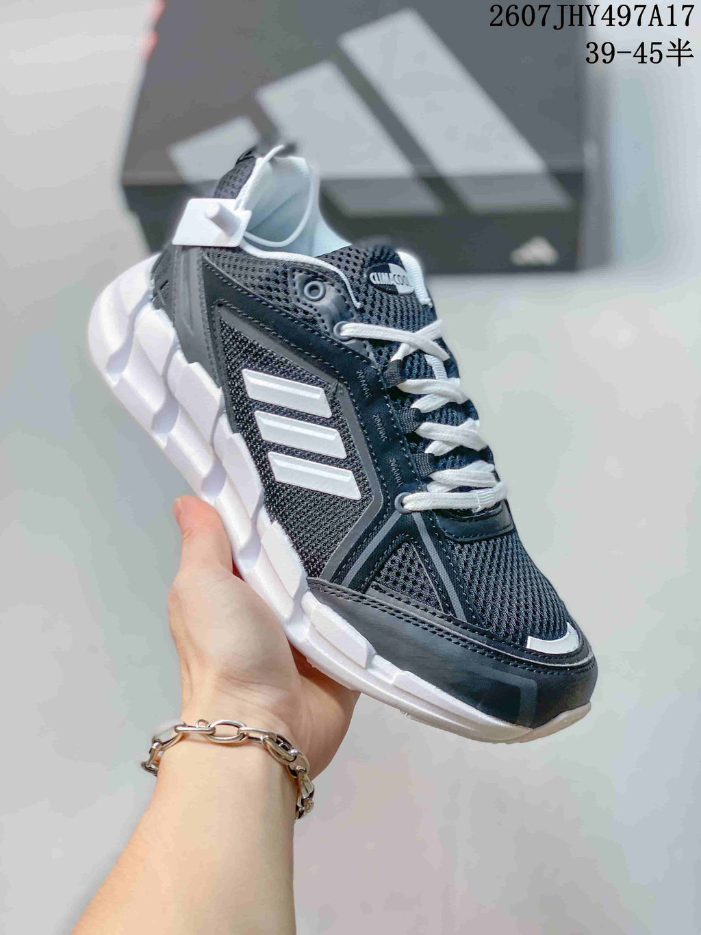 Black and gray Adidas Climacool Ventage sneaker with white side stripes and a white segmented sole.