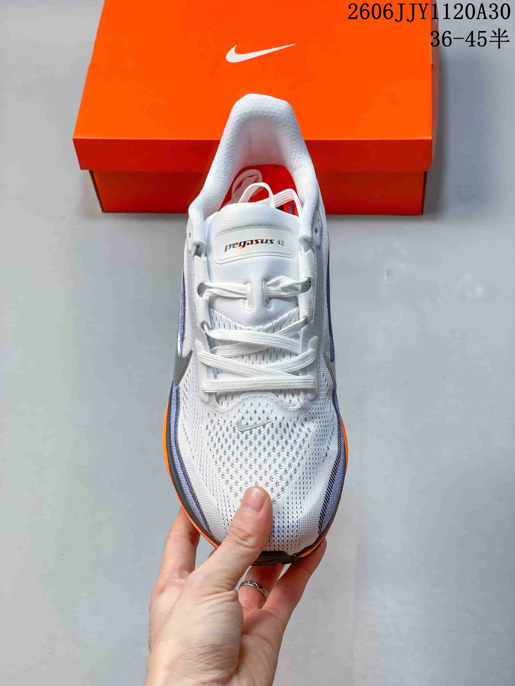 Top view of the perforated upper and laces of a Nike Pegasus 42 shoe.