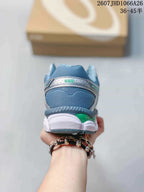 Rear view of the ASICS Gel-Cumulus 16 sneaker showing the padded blue heel collar, silver heel panel and green accent.