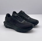 Front three-quarter view of a pair of all-black Alo sneakers with lace-up fronts and chunky soles.