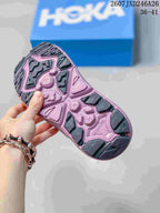 Close-up of the patterned black and pink outsole on a HOKA Hopara sandal.