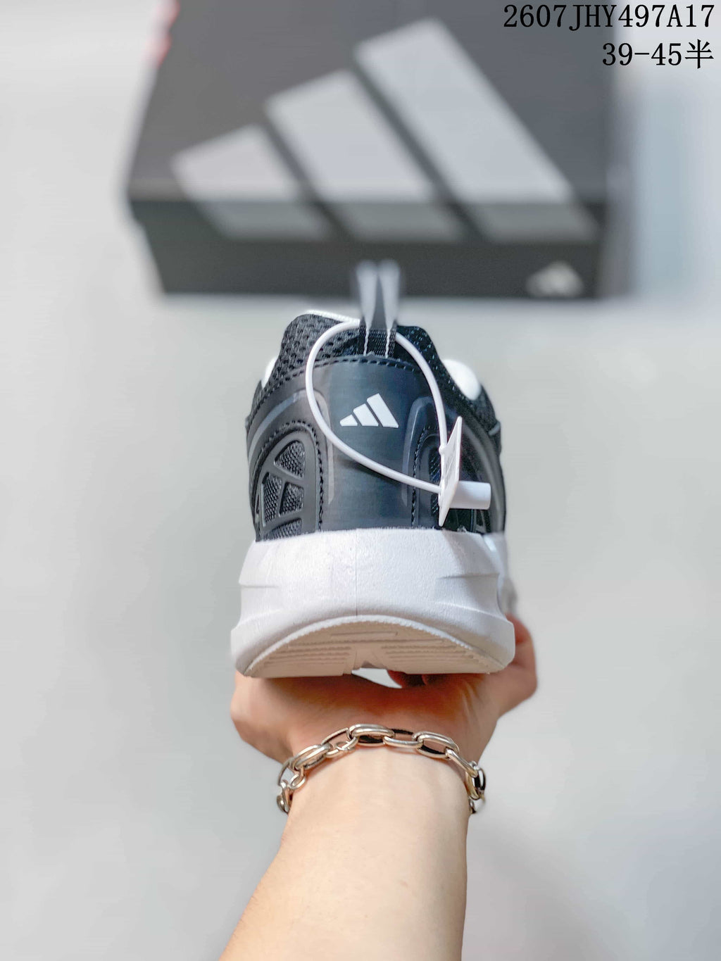 Rear view showing the padded heel, heel branding, and white segmented midsole.