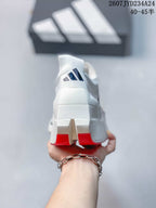 Rear view of the white shoe showing the adidas logo and red outsole sections.