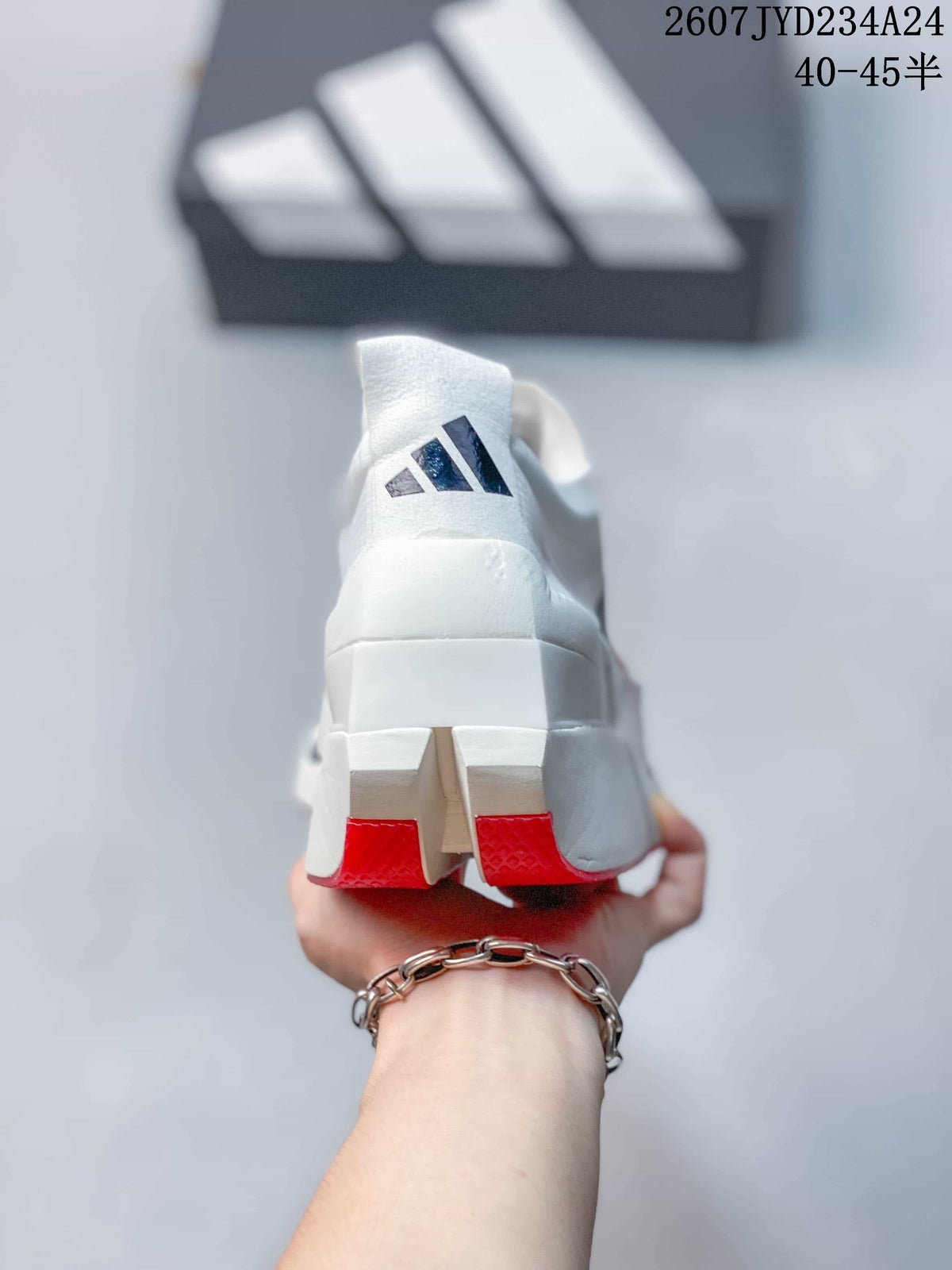 Rear view of the white shoe showing the adidas logo and red outsole sections.