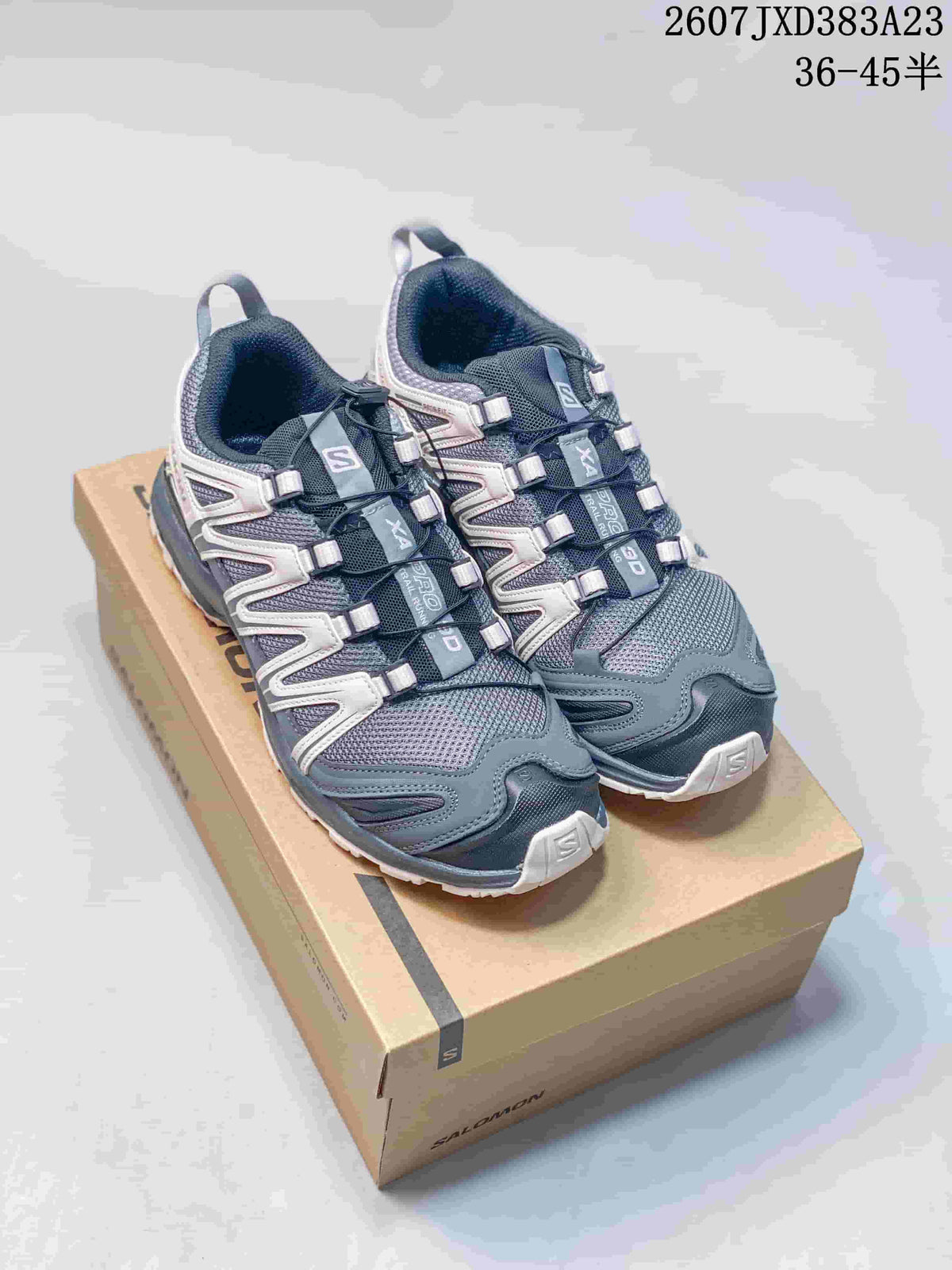 Pair of ash gray Salomon XA Pro 3D sneakers displayed on a shoebox; source image text shows code 2607JXD383A23 and size range 36–45.