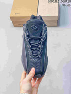 Front view of the lace-up sneaker with mesh-like detailing.