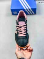 Top view showing the black toe box, pink laces, and padded pink collar.