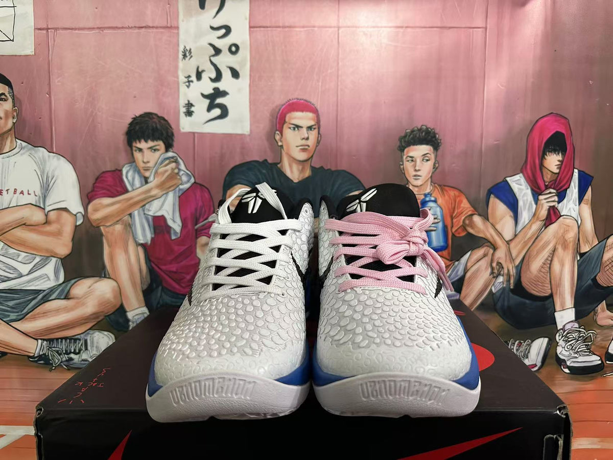 Front view showing the textured white uppers, black tongues, and contrasting pink and white laces.