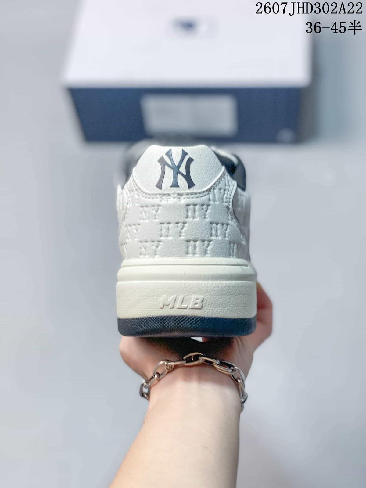 Rear view of the sneaker showing the navy-and-white heel design, MLB branding, and layered sole.