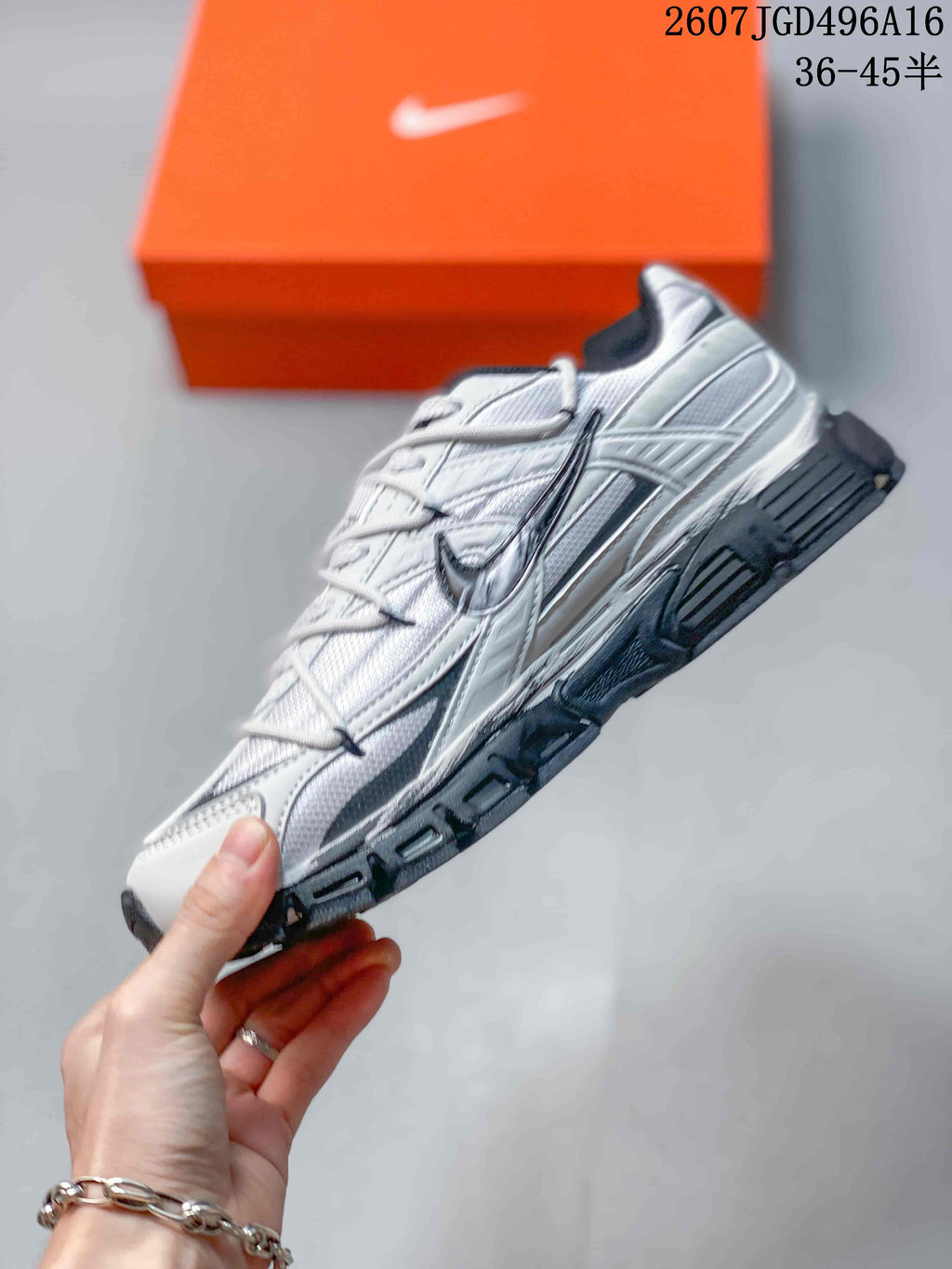 Side profile of the white and dark gray Nike Initiator sneaker with layered panels and a chunky sole.