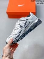 Side profile of the white and dark gray Nike Initiator sneaker with layered panels and a chunky sole.
