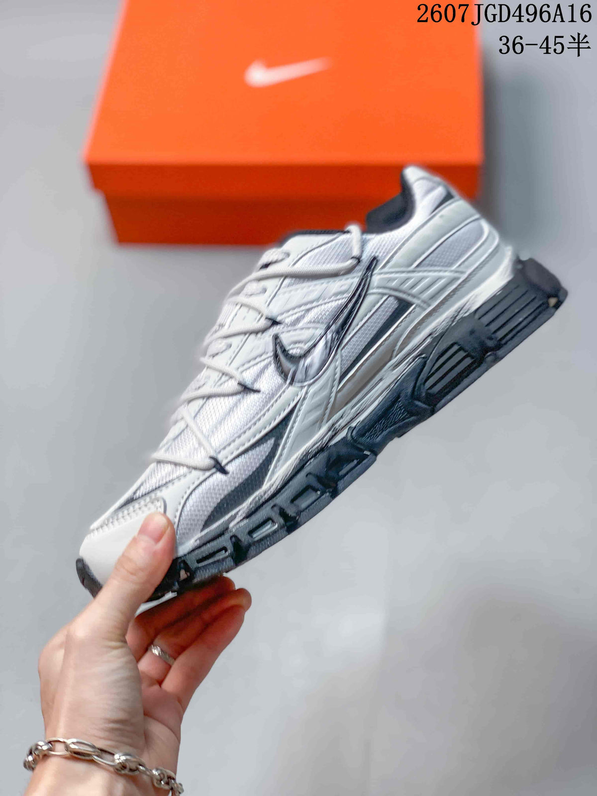 Side profile of the white and dark gray Nike Initiator sneaker with layered panels and a chunky sole.