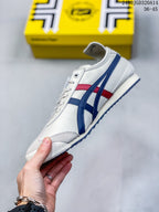 Side profile of the white low-top sneaker with blue and red stripes, lace-up front, and textured toe overlay.
