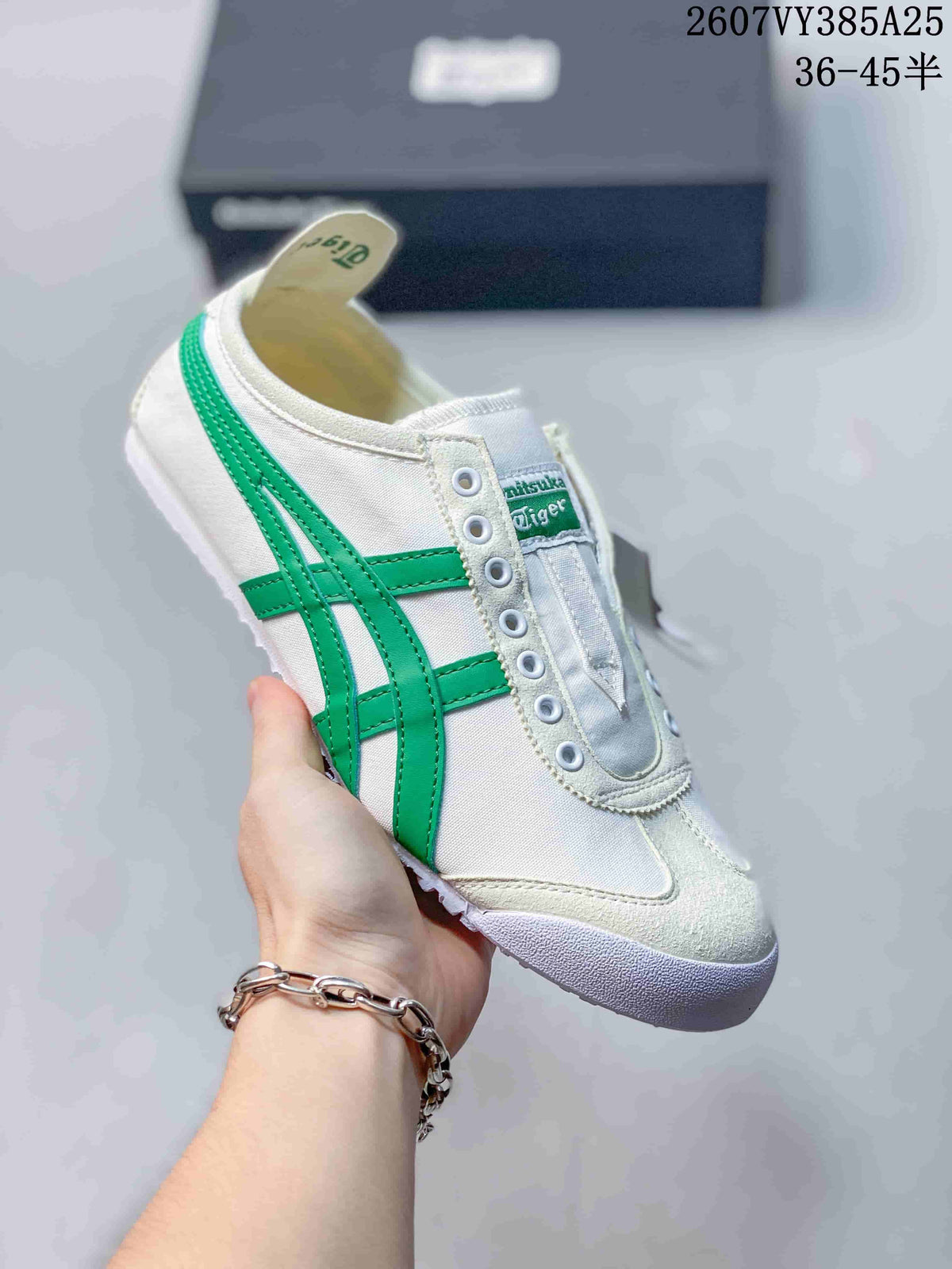 White Onitsuka Tiger slip-on sneaker with bright green side stripes and a white outsole.