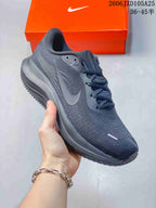 Side view of a charcoal Nike Air Zoom Pegasus running shoe.