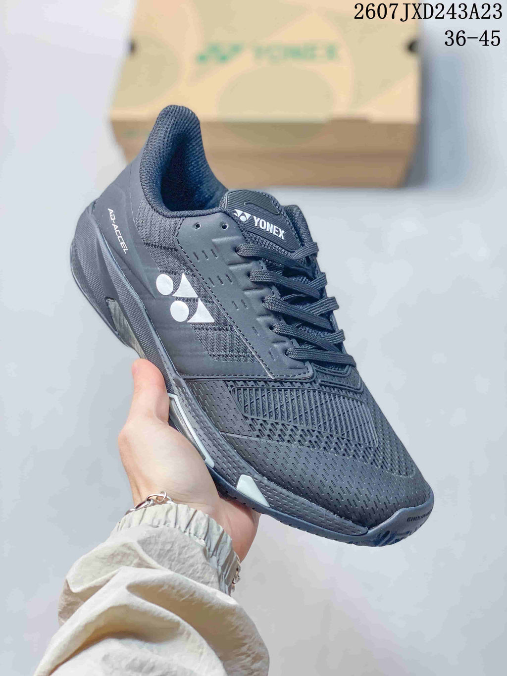 Angled side view of the dark Yonex AD ACCEL shoe showing the lace system, side logo and low-top shape.
