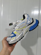 Side view of the white Nike 9074 Runner 2 sneaker showing the blue heel section, black detailing and sculpted sole.