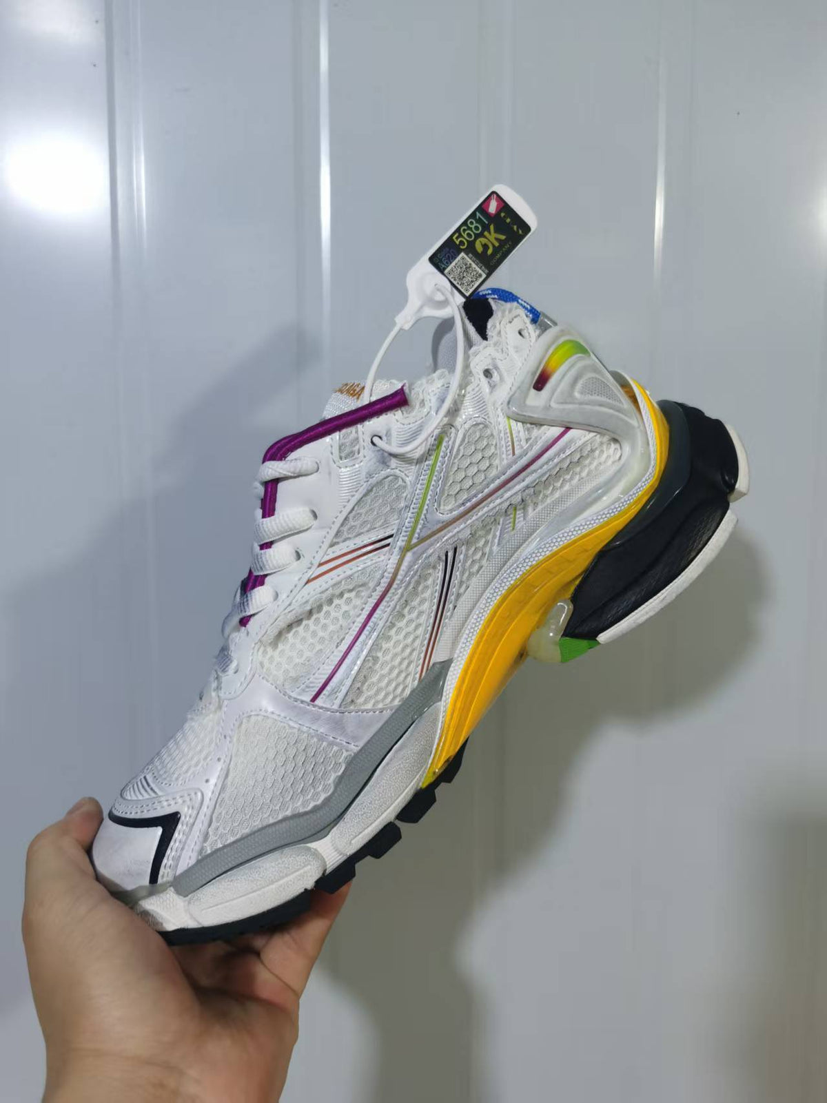 Rear and lateral view of the white Puma Runner Gradient sneaker showing the layered upper, contrasting heel structure and multicolor outsole.