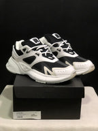 Pair of white and black AMIRI MA Runner sneakers displayed on a black shoe box; the box label shows size 41.