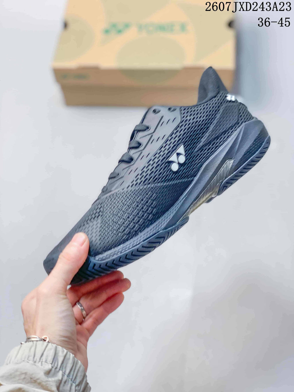 Side profile of a dark Yonex AD ACCEL shoe showing the mesh-like upper, white logo and outsole.