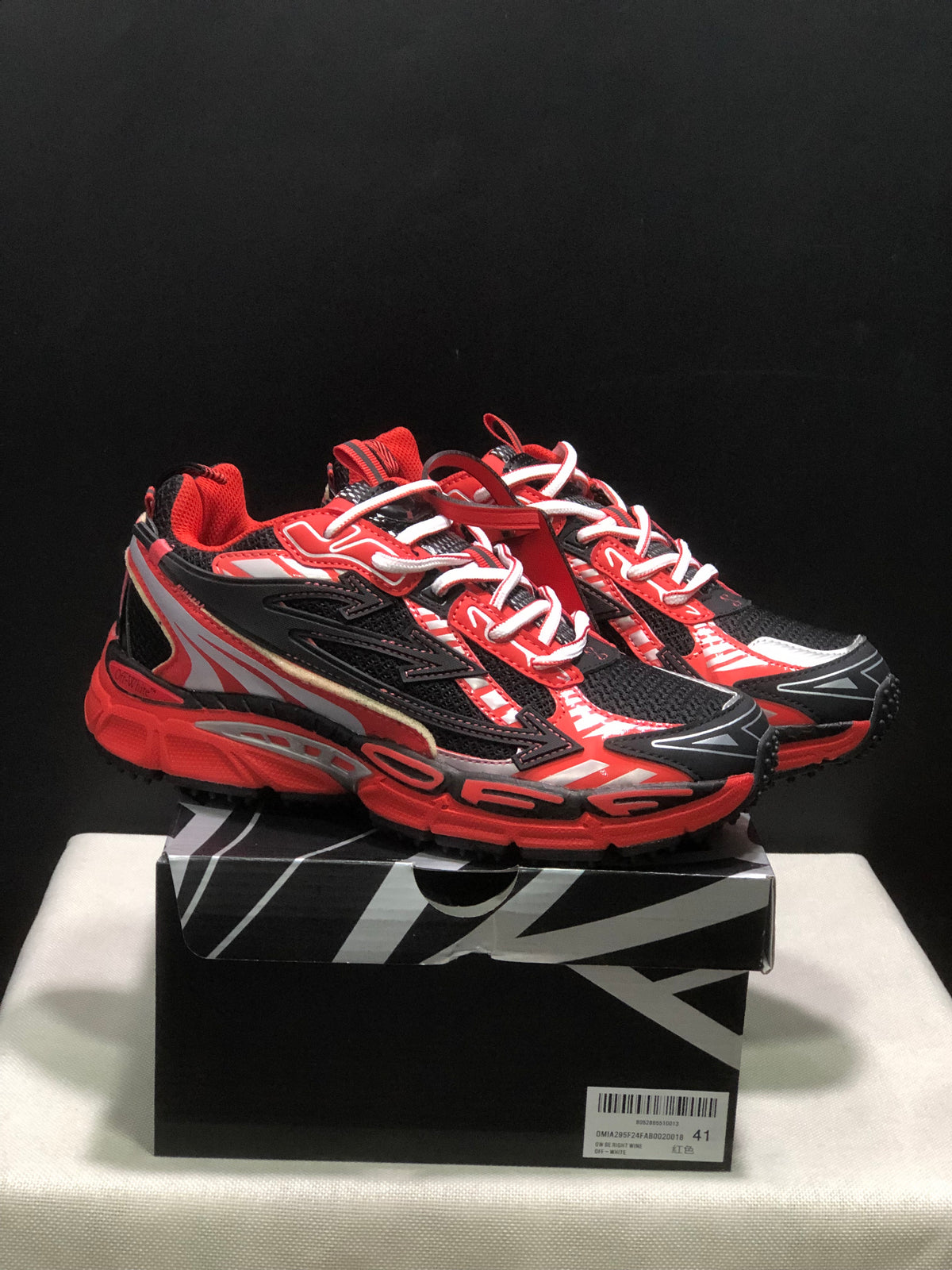 Pair of red, black, and white OFF-WHITE Be Right Back sneakers displayed on a branded-style shoe box; the box label shows size 41.
