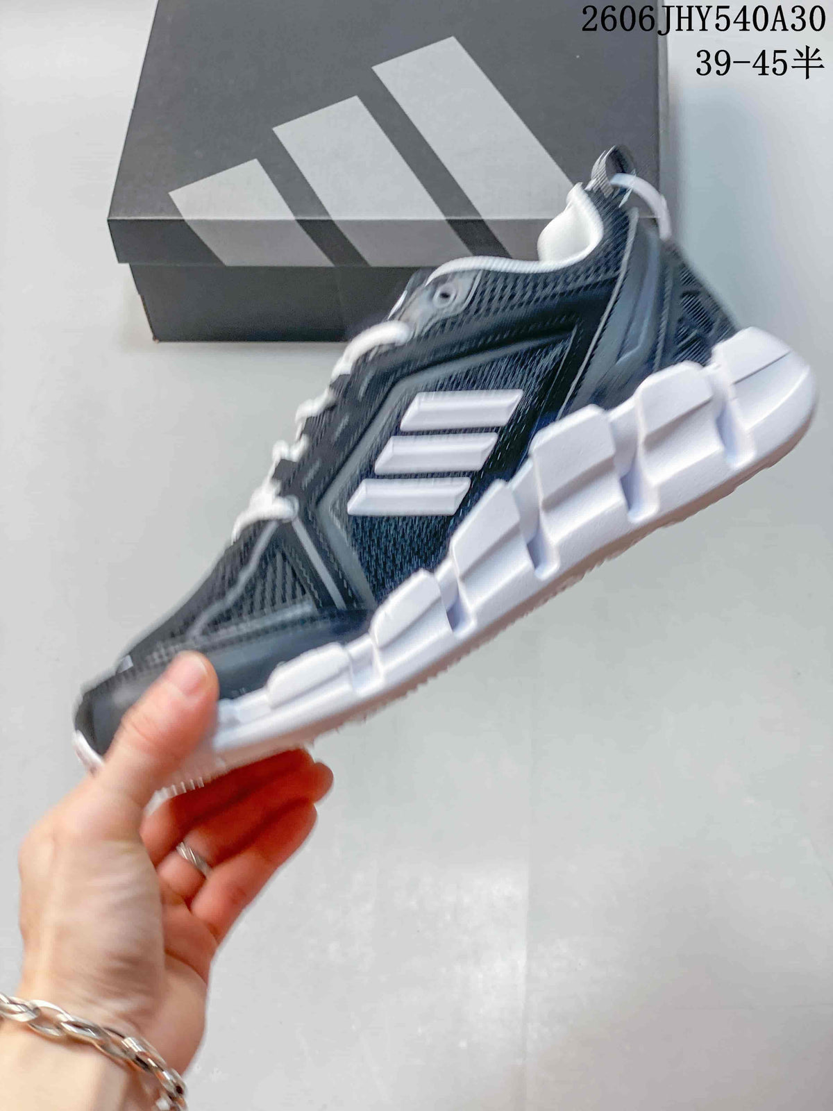 Side view of the shoe showing the mesh upper, white stripes, and sculpted sole.