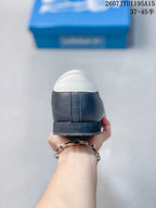 Rear view showing the white heel panel, navy heel counter and dark outsole.
