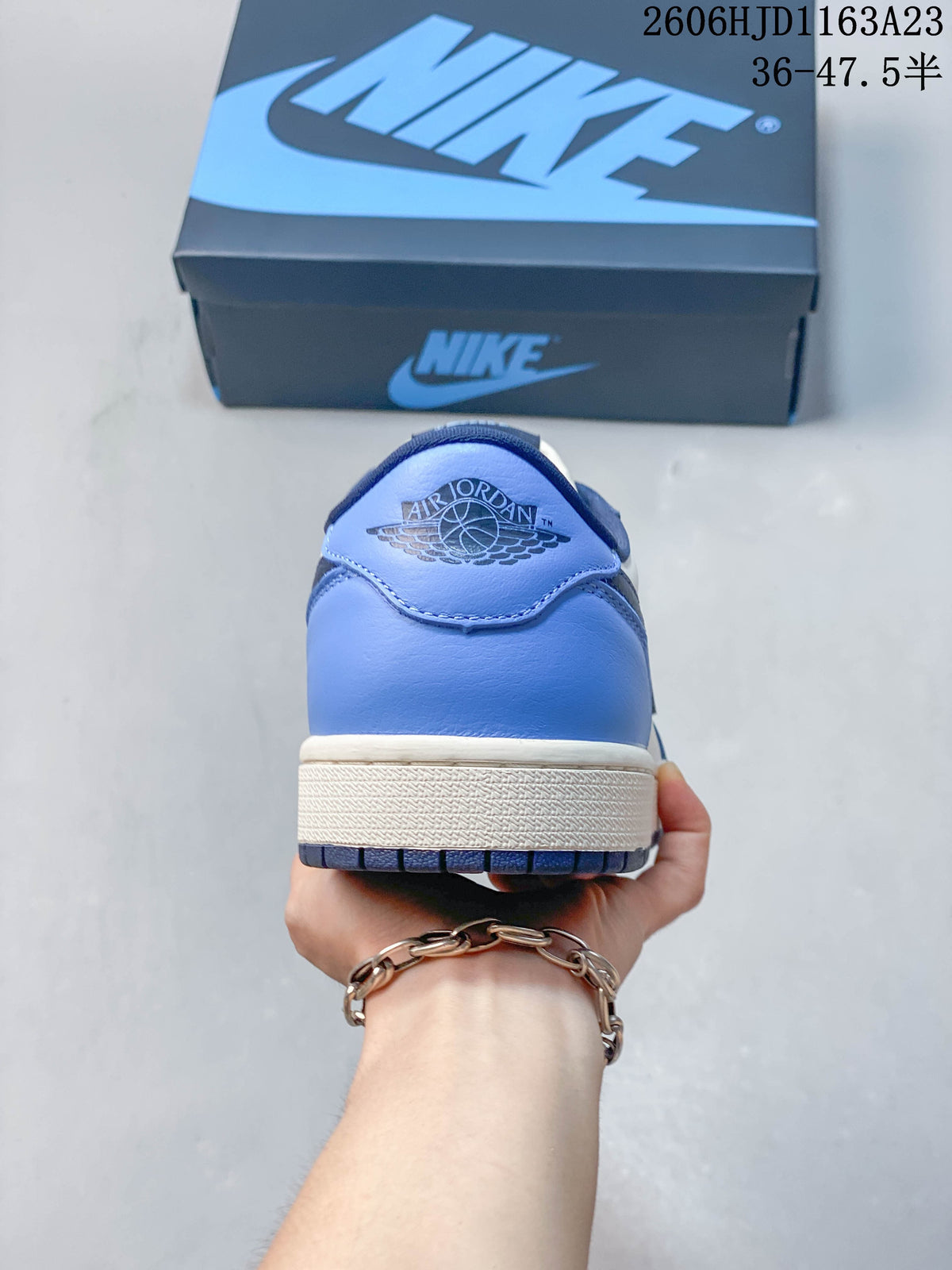 Rear view of a blue and white Jordan Air Jordan 1 Low sneaker