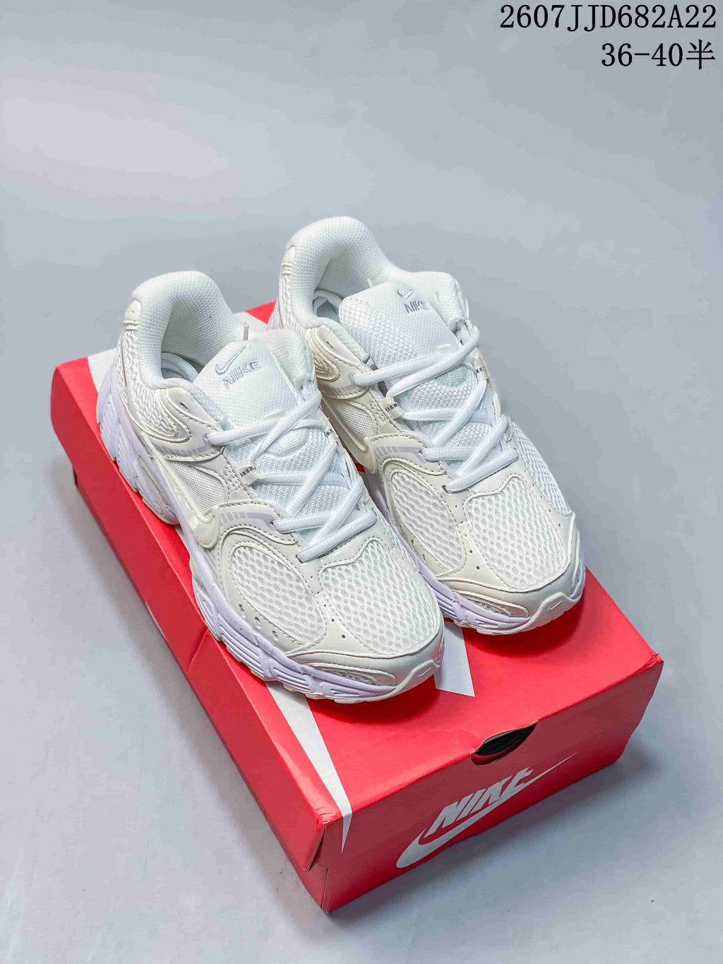 White Nike V5 RNR sneakers displayed on a red shoebox, with style code 2607JJD682A22 and size range text visible above.