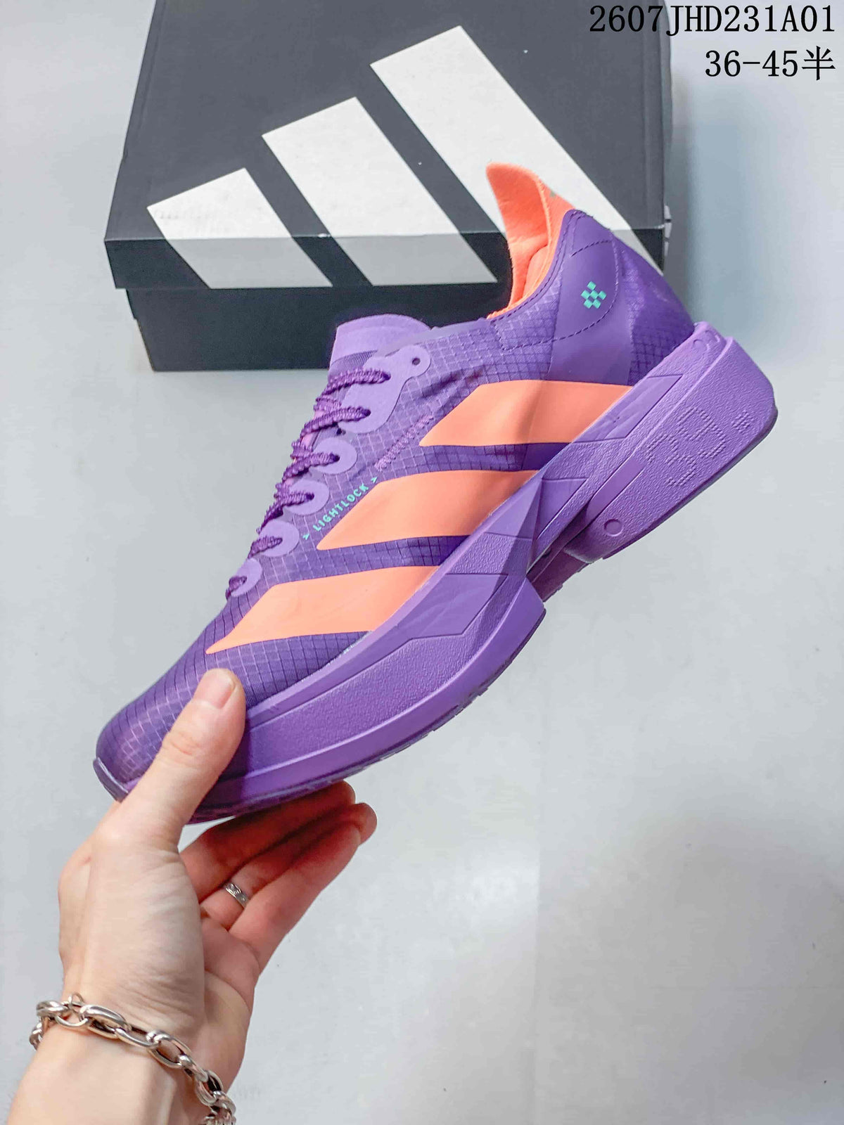 Side profile showing purple upper, coral stripes and sculpted sole