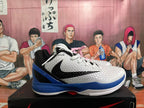 Side view highlighting the black side branding, textured white upper, blue heel, and visible Zoom marking.