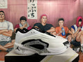 Side view of a white and black Jordan Luka basketball shoe with patterned side detailing and a personalized heel graphic.