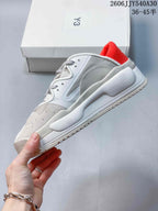 Side profile of a white and grey Y-3 Rivalry sneaker