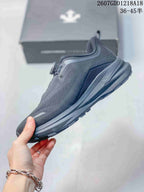 Side profile of a dark gray running shoe showing the layered sole and textured upper.